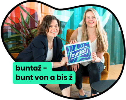 Zwei buntaž-Botschafterinnen mit buntaž-Schild – bunt von A bis ž